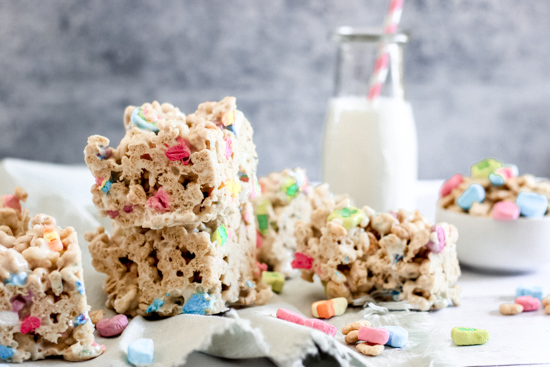 Lucky Charms marshmallow treats next to a glass of milk
