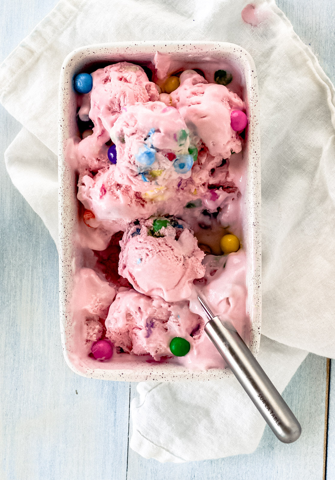 a pink bubblegum ice cream recipe is scooped into a rectangular container