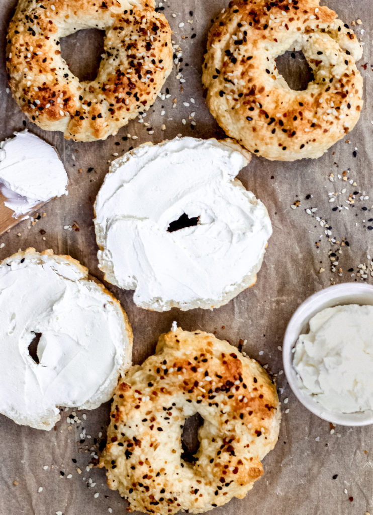 Recipe for two ingredient bagel. Bagels laying out some with cream cheese on them