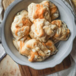 Overhead shot of a serving bow2l filled with chicken puff pastries filled with cream chicken mixture and cheese.