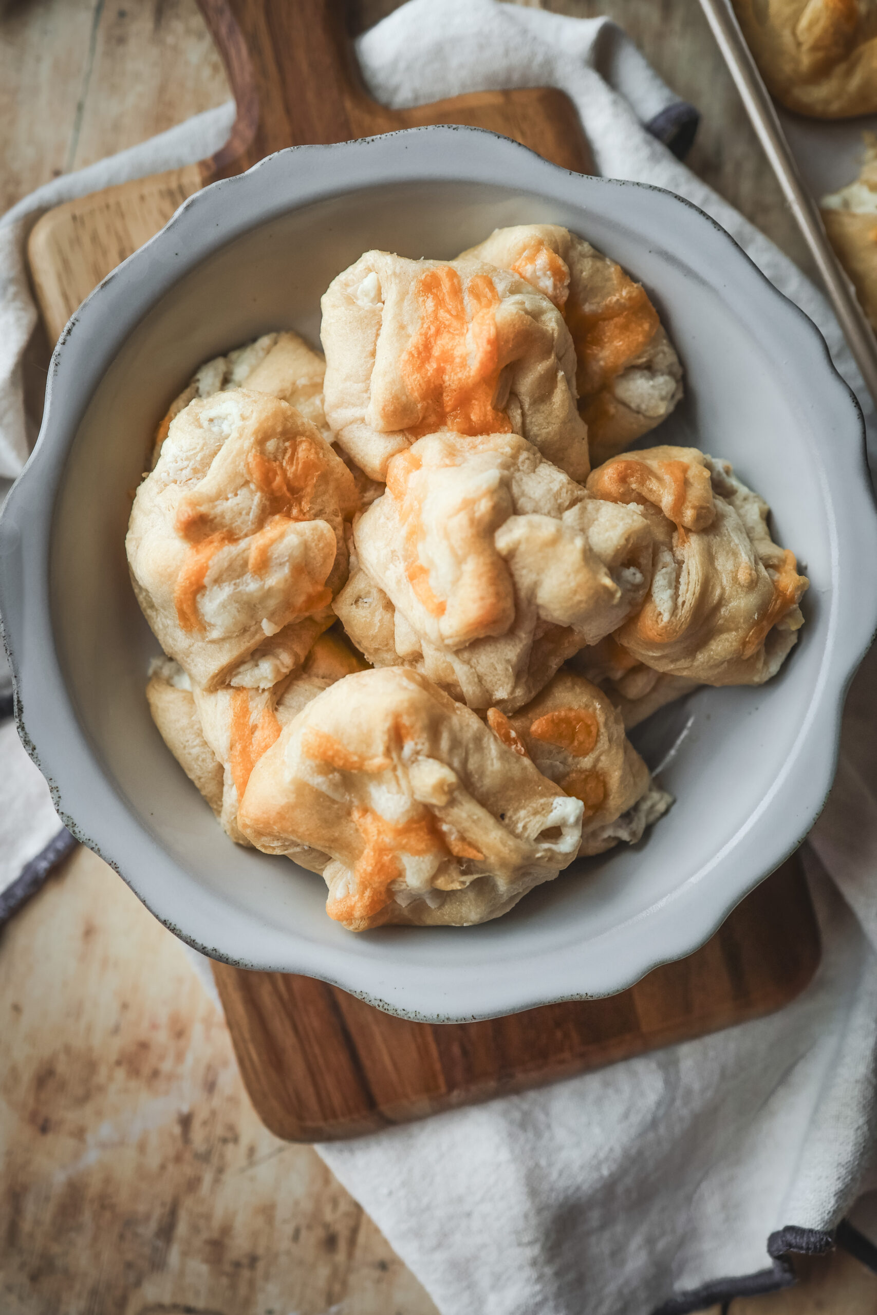 Overhead shot of a serving bow2l filled with chicken puff pastries filled with cream chicken mixture and cheese.