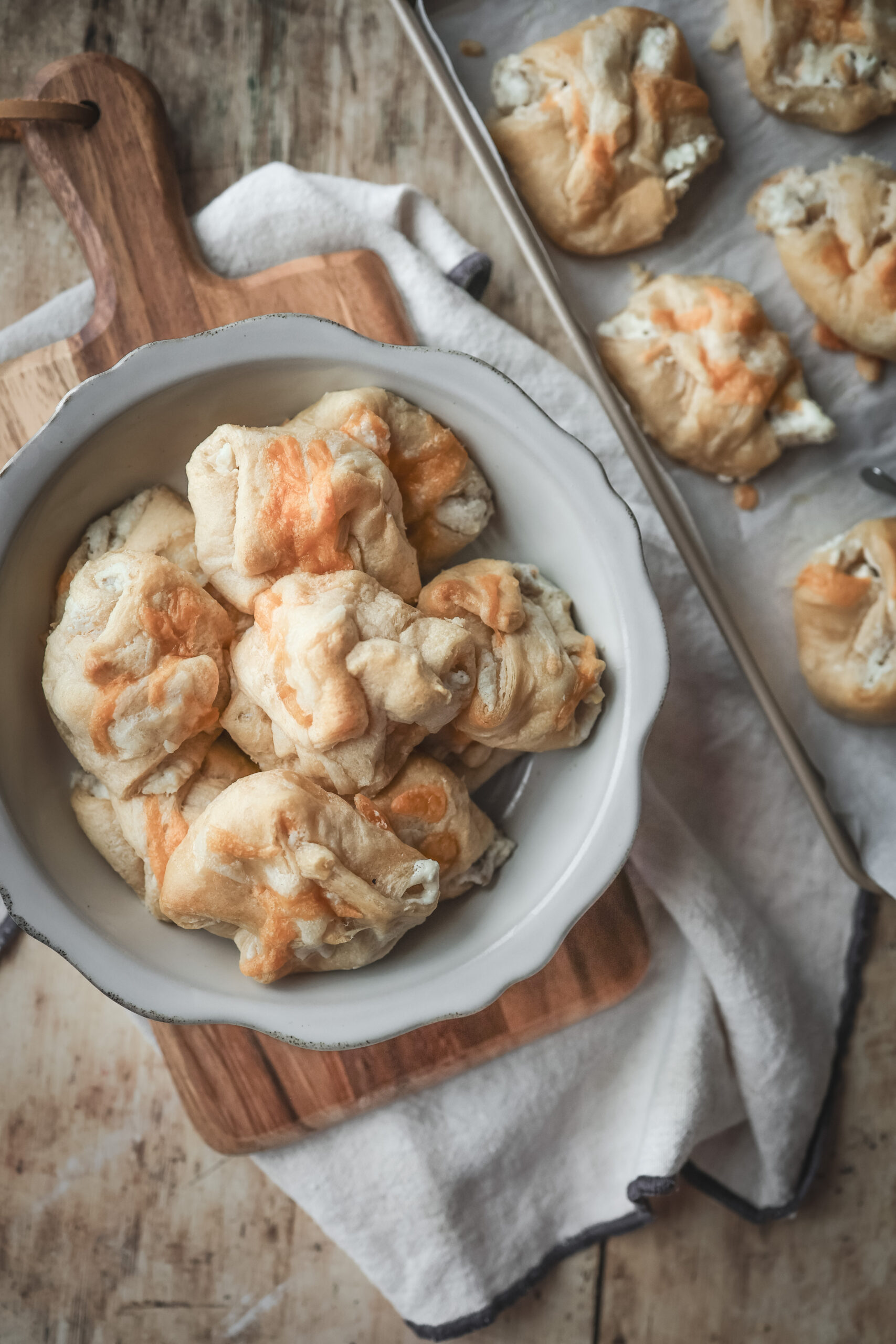 Overhead shot of a serving bow2l filled with chicken puff pastries filled with cream chicken mixture and cheese.