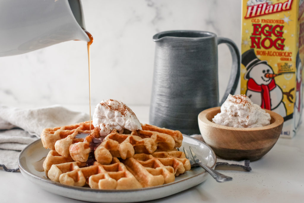 easy eggnog waffles on a plate with cinnamon whipped cream