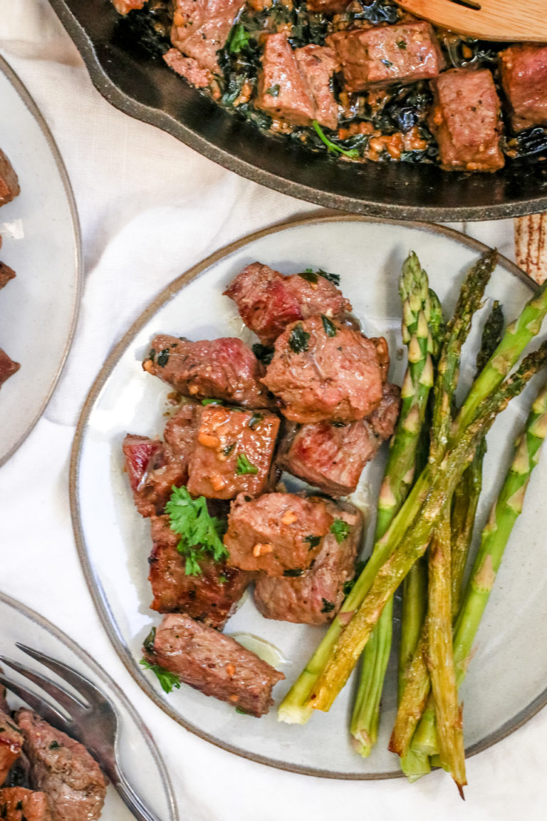 Overhead look of a plate full of One Pan Garlic Steak Bites covreed in a butter sauce