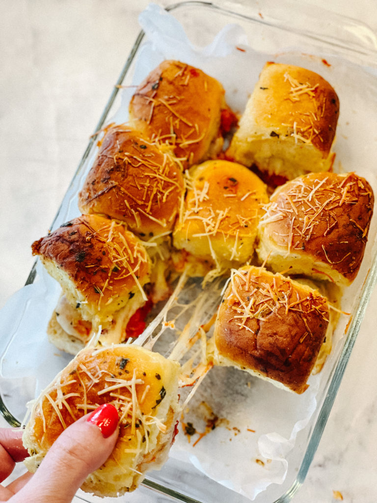 overhead view of a slider being pulled with melty cheese