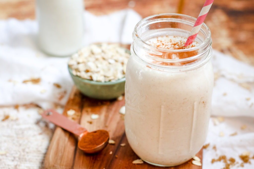 straight on view of a creamy cinnamon roll smoothie in a glass jar