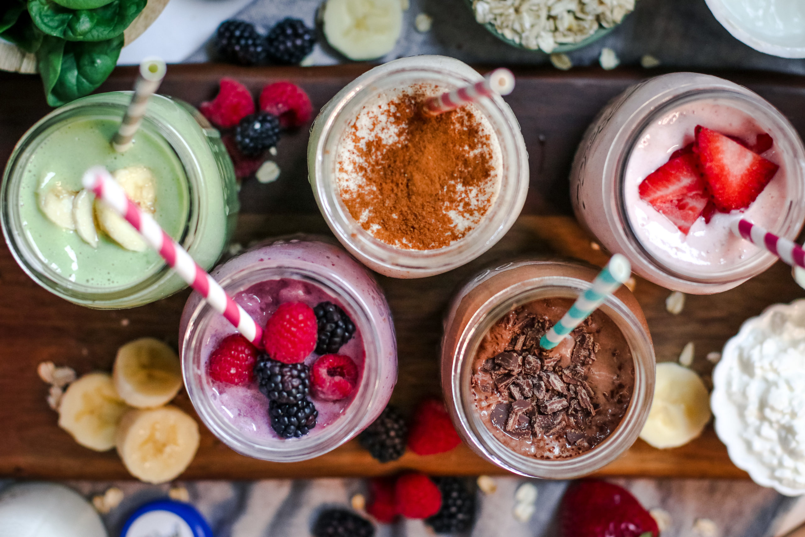 overhead view of 5 colorful smoothies
