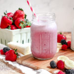 Straight on view of a pink triple berry smoothie in a glass jar