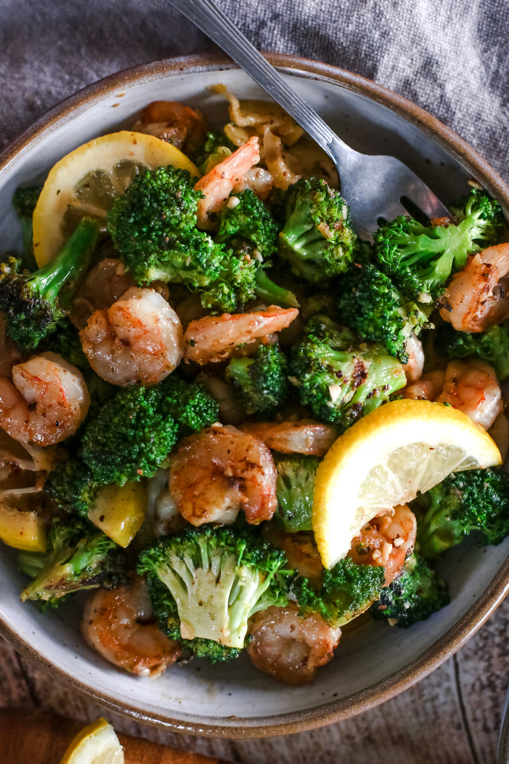 overhead view f a plate of garlic butter shrimp and broccoli