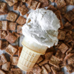 view of a cone with a scoop of cinnamon toast crunch cereal milk ice cream