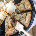 overhead view of a skillet cookie with ice cream scoops