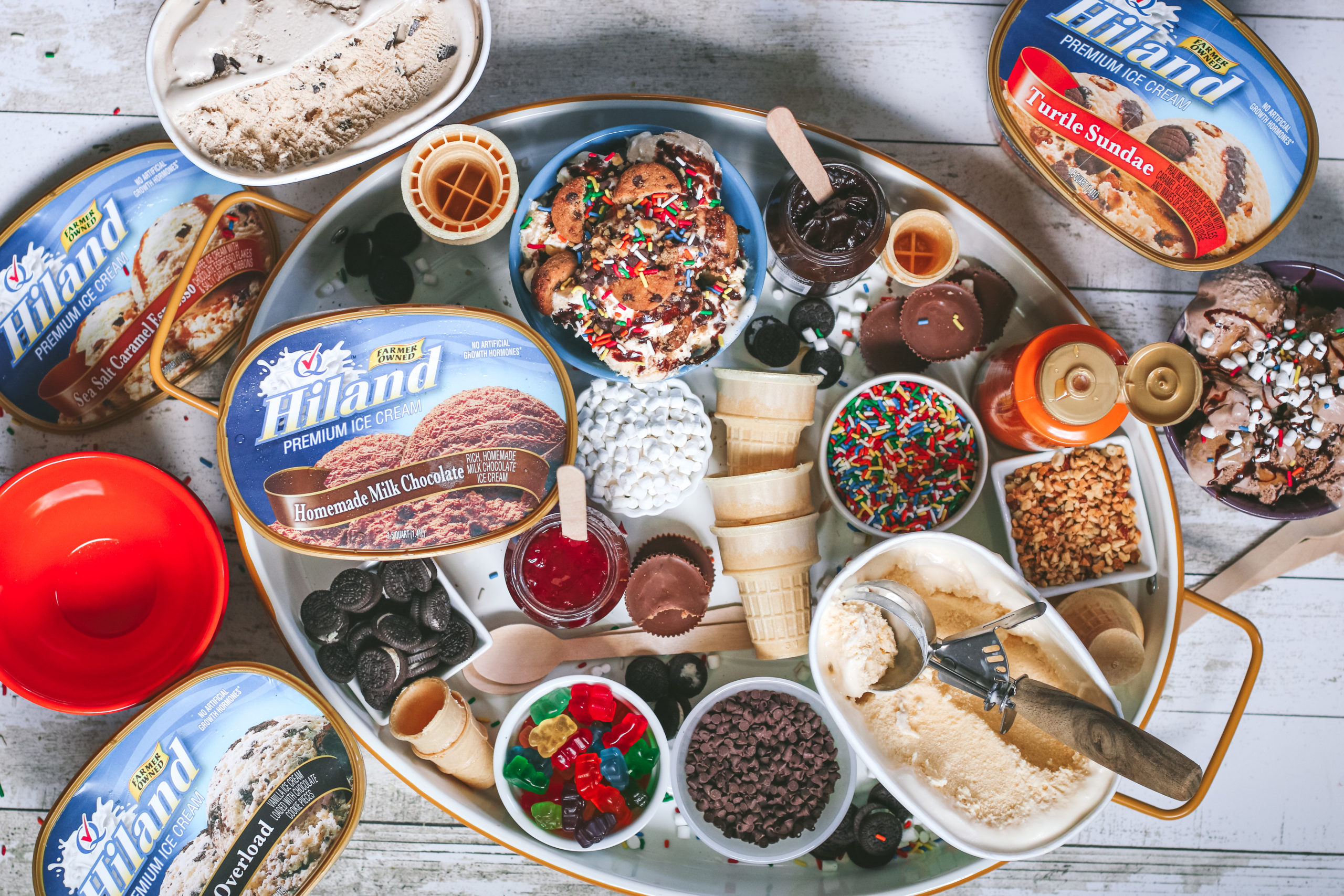 overhead view of a board with ice cream and sundae toppings