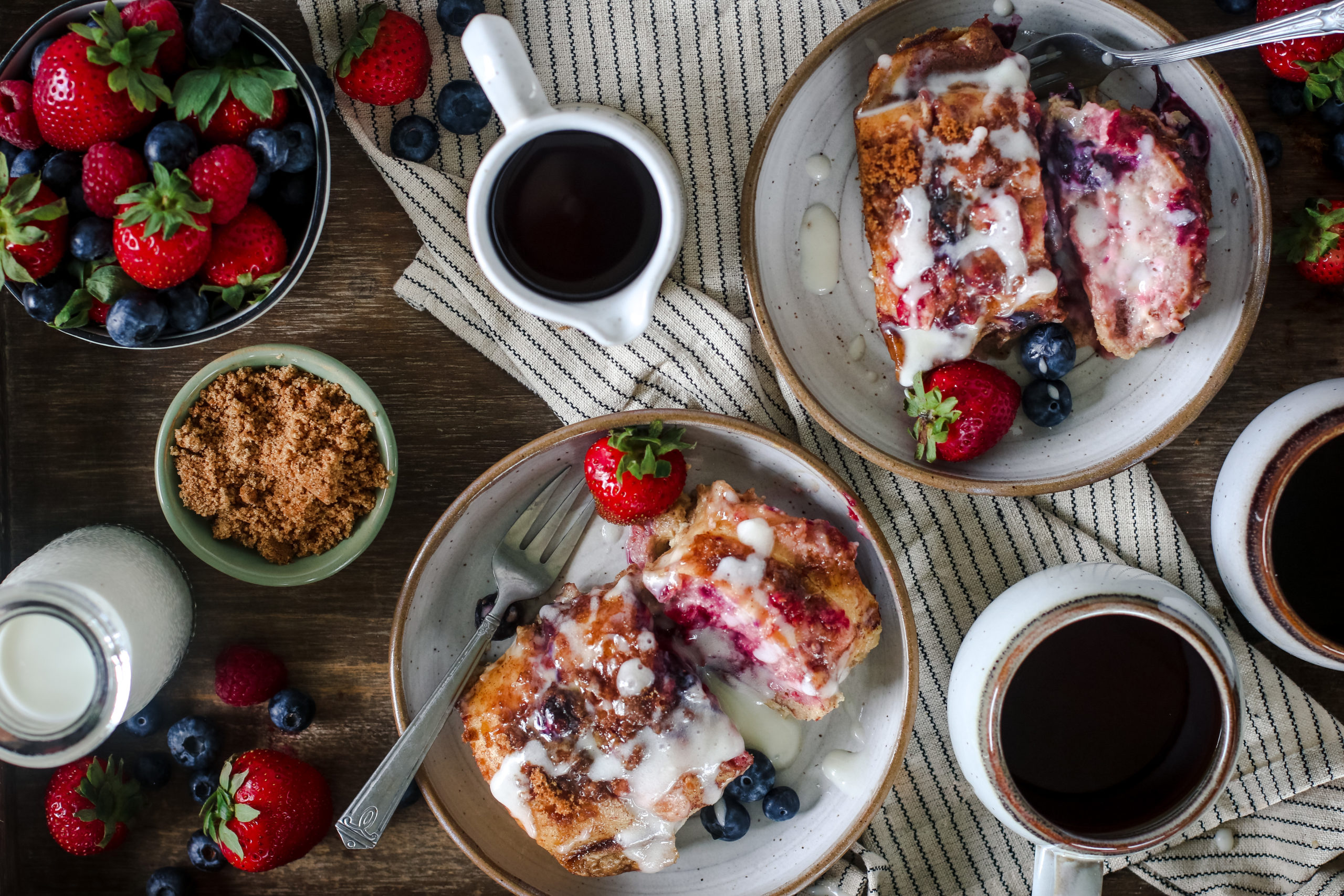 overhead view of a baking dish with berries and cream baked french toast