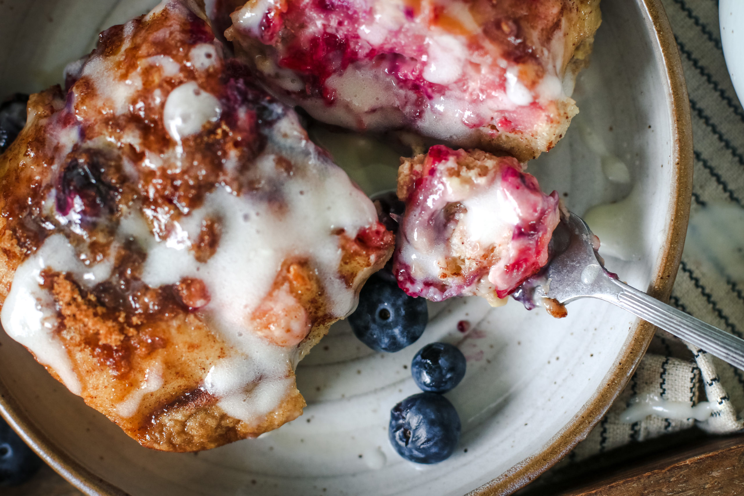 overhead view of a baking dish with berries and cream baked french toast