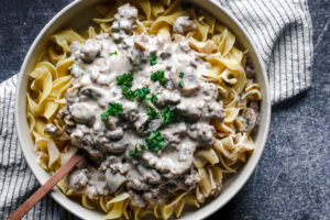 overhead view of a bowl of egg noodles and creamy beef stroganoff