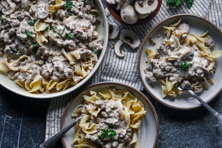 overhead view of a bowl of egg noodles and creamy beef stroganoff