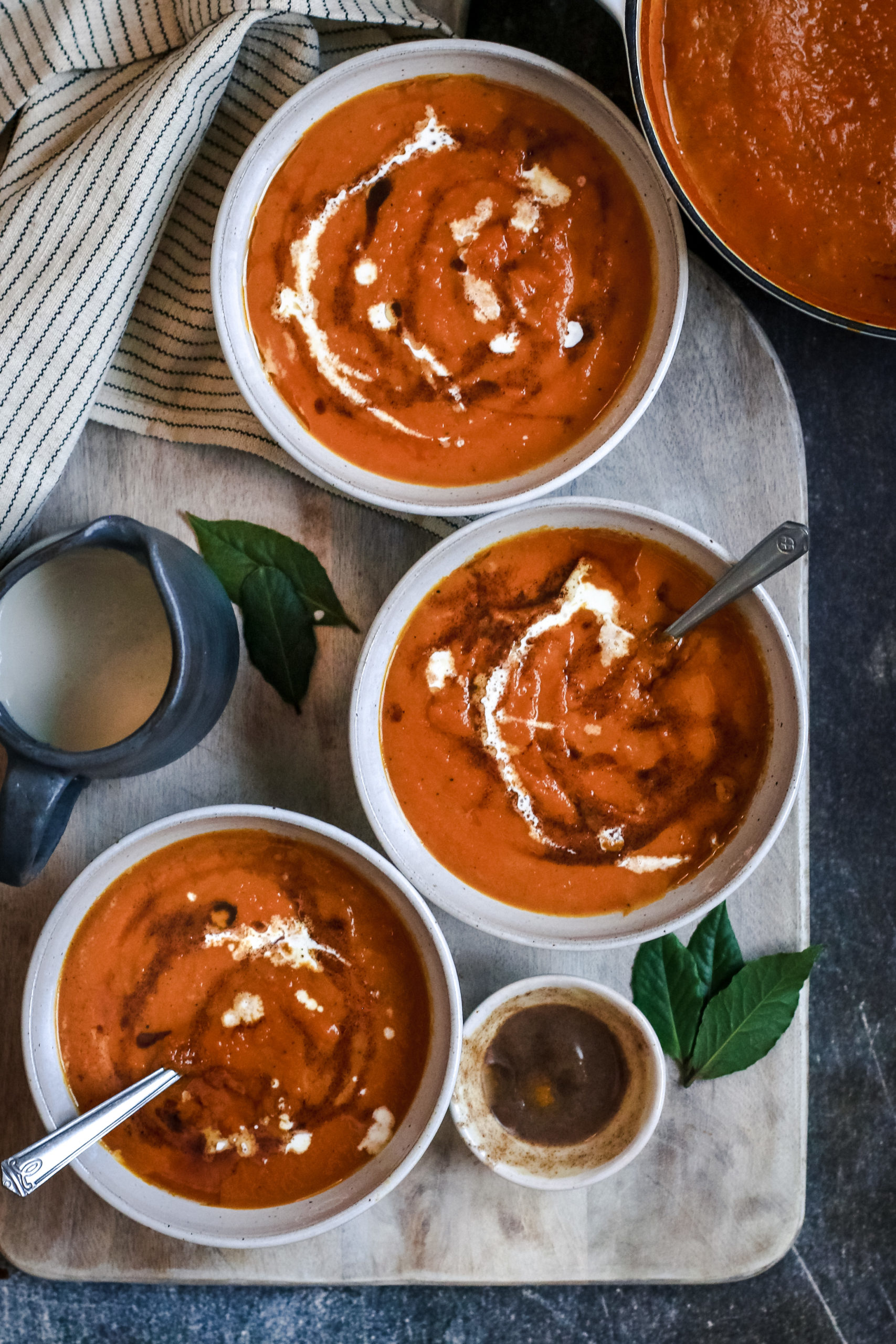 overhead view of creamy pumpkin soup with vanilla brown butter drizzle
