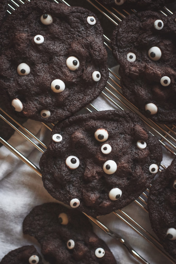 overhead view of chocolate cookies filled with candy eyeballs