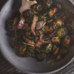 overhead view of a bowl of roasted brussels sprouts with bacon