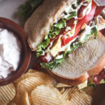 Overhead view of a BLT sandwich with sour cream spread