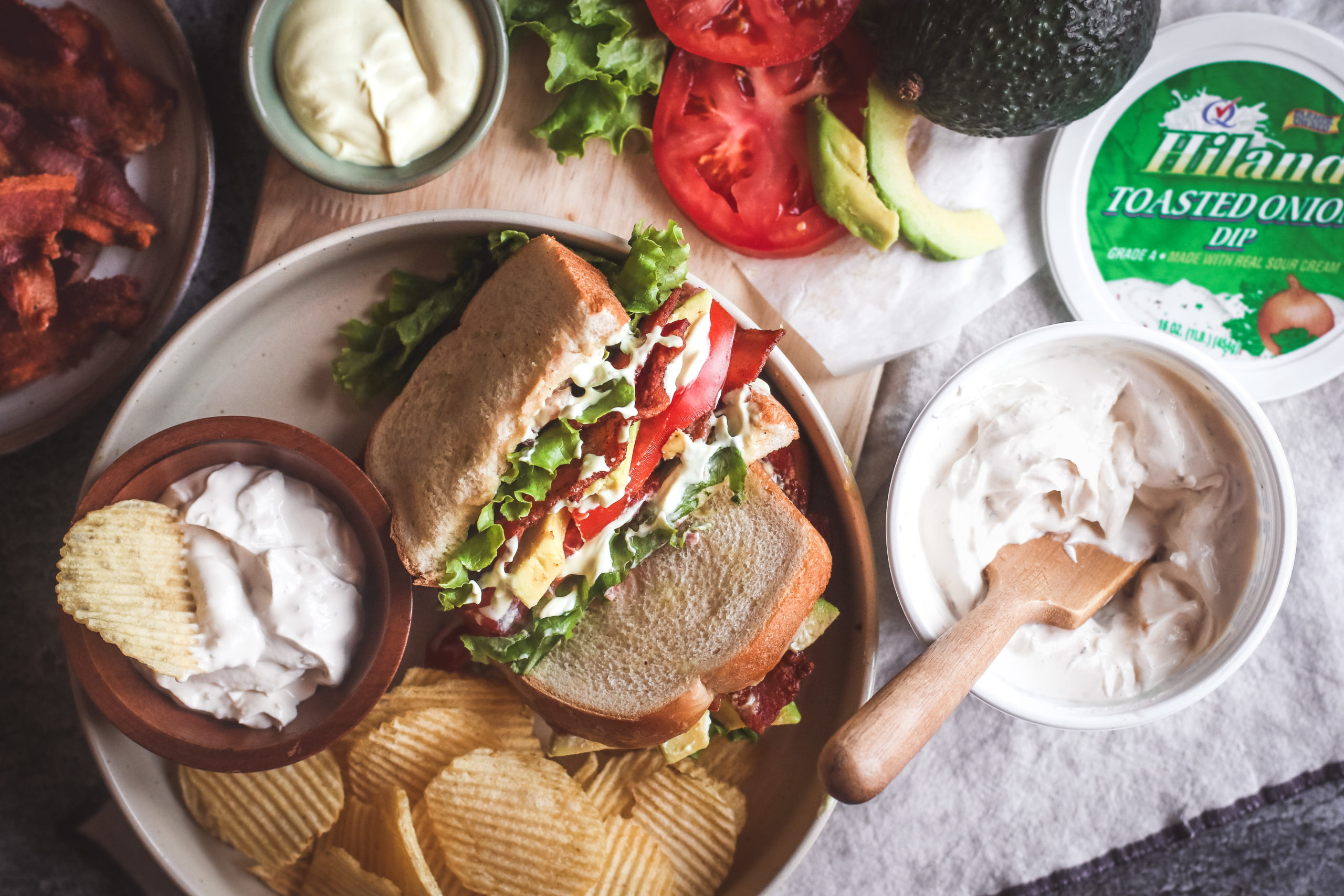 Overhead view of a BLT sandwich with sour cream spread