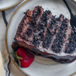 over top view of a layered dark chocolate mousse cake with drizzles of chocolate ganache