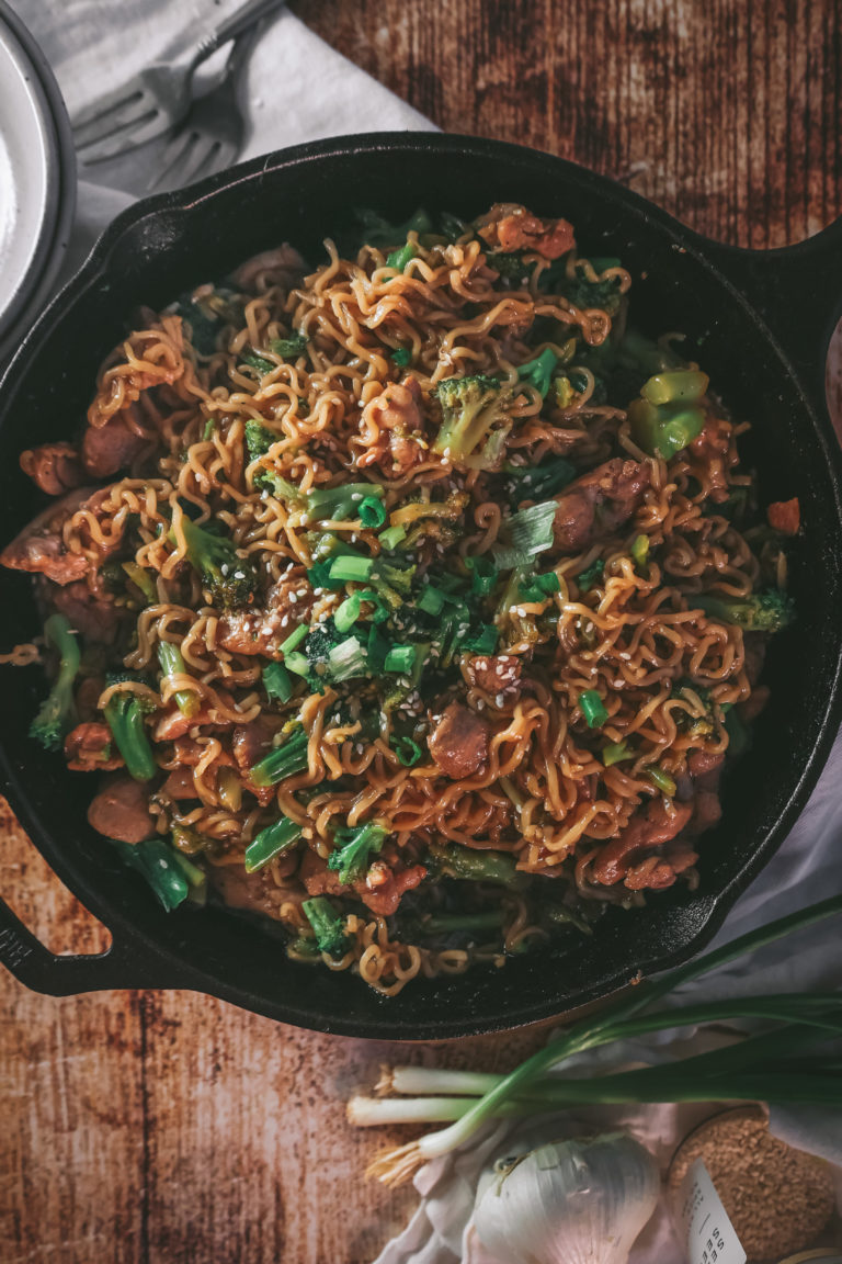 overhead view of a pan of ramen noodle chicken broccoli stir fry