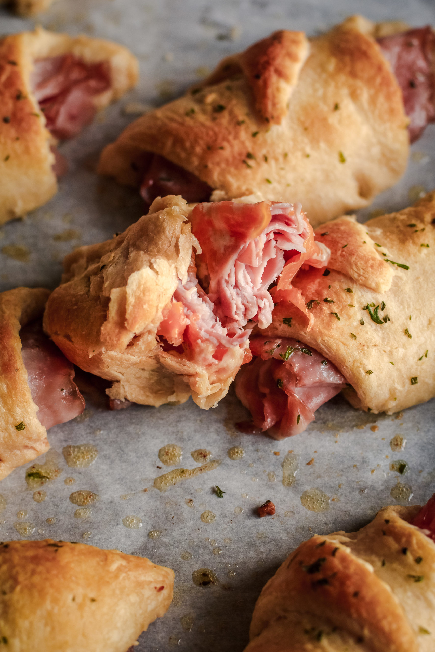 overhead view of a ham and cheese roll up with crescent rolls, ham and melted cheese
