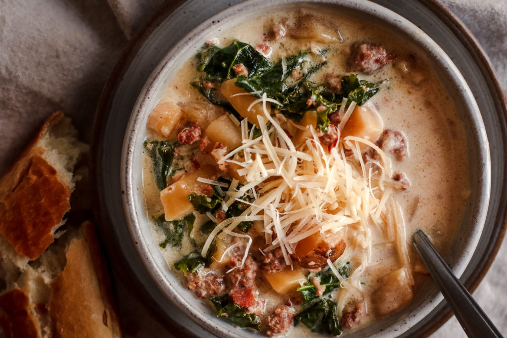 overhead view of a bowl of creamy zuppa toscana soup