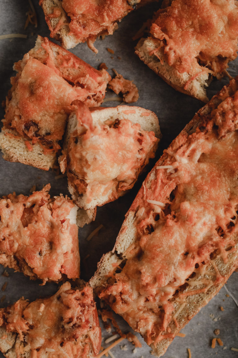 overhead view of a sheet pan of buffalo chicken cheesy bread