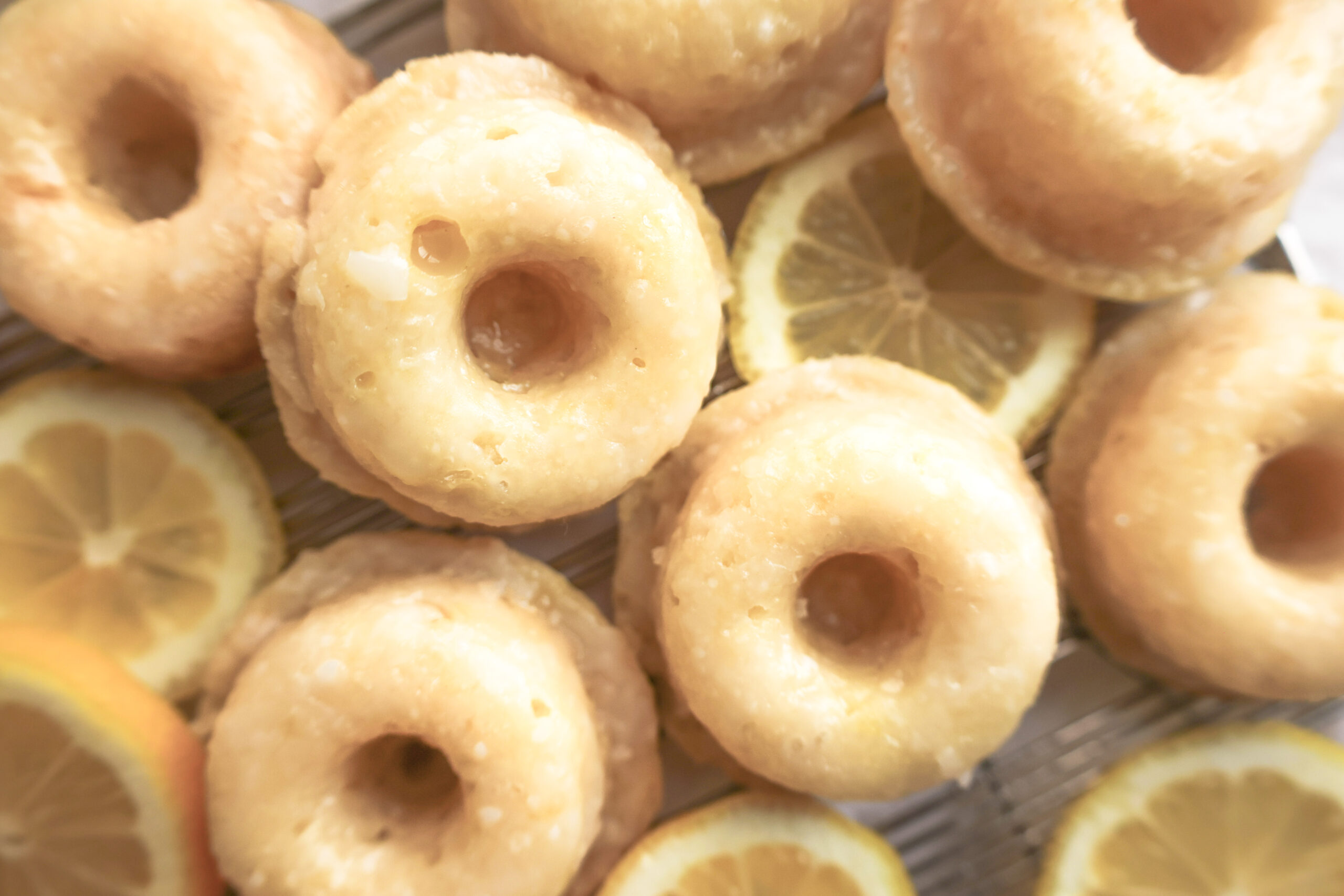 overhead view of mini baked lemonade donuts with lemon slices