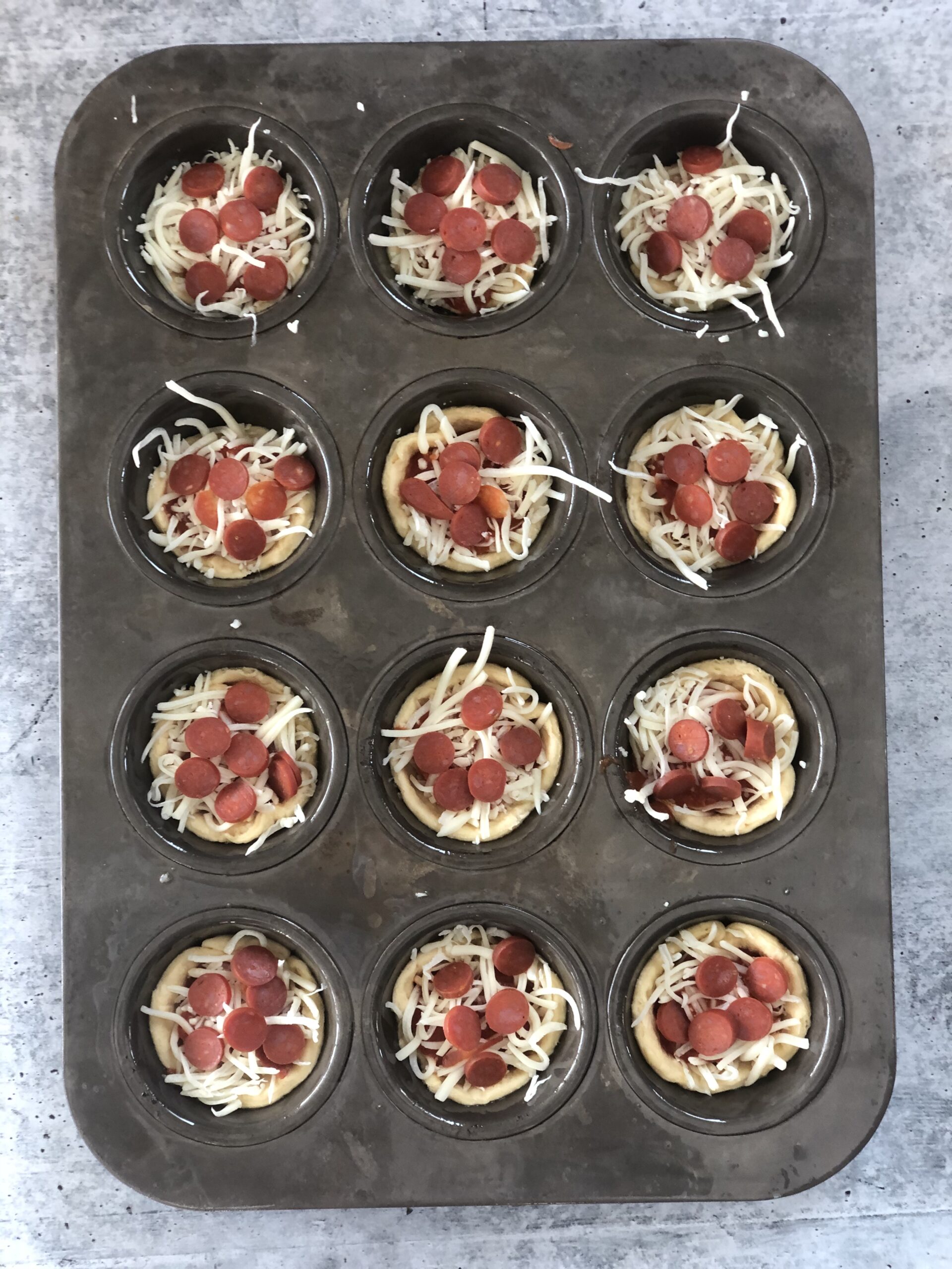 overhead view of easy pizza cups filled with pepperoni and cheese