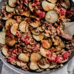 overhead view of a skillet of zucchini and sausage stovetop casserole