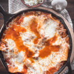 overhead view of a skillet of cheesy lasagna skillet