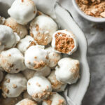 Overhead shot of a bowl of pumpkin spice truffles covered in white chocolate