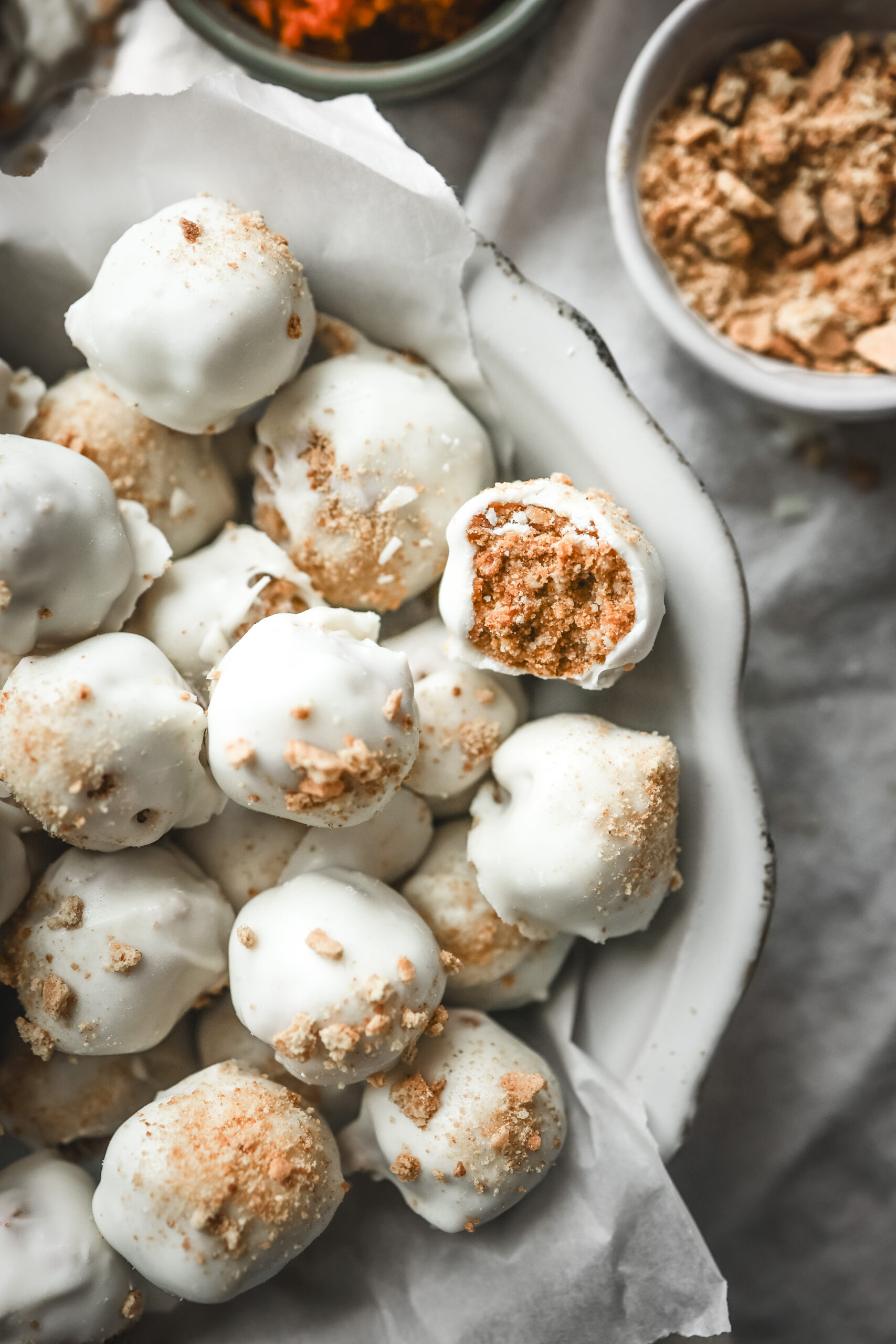Overhead shot of a bowl of pumpkin spice truffles covered in white chocolate