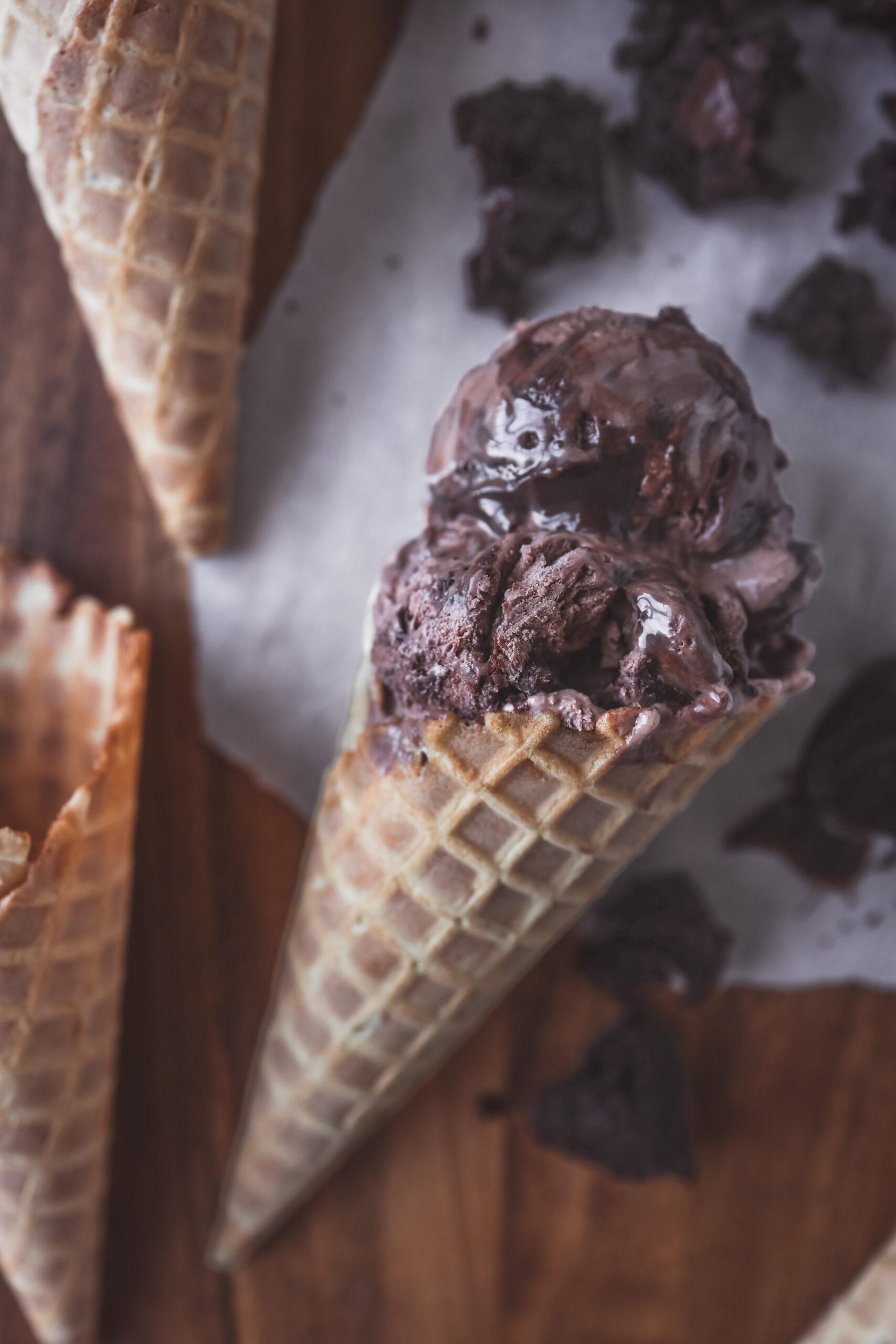 Scoop of rich and creamy no churn chocolate fudge brownie ice cream with chunks of brownie in a white bowl