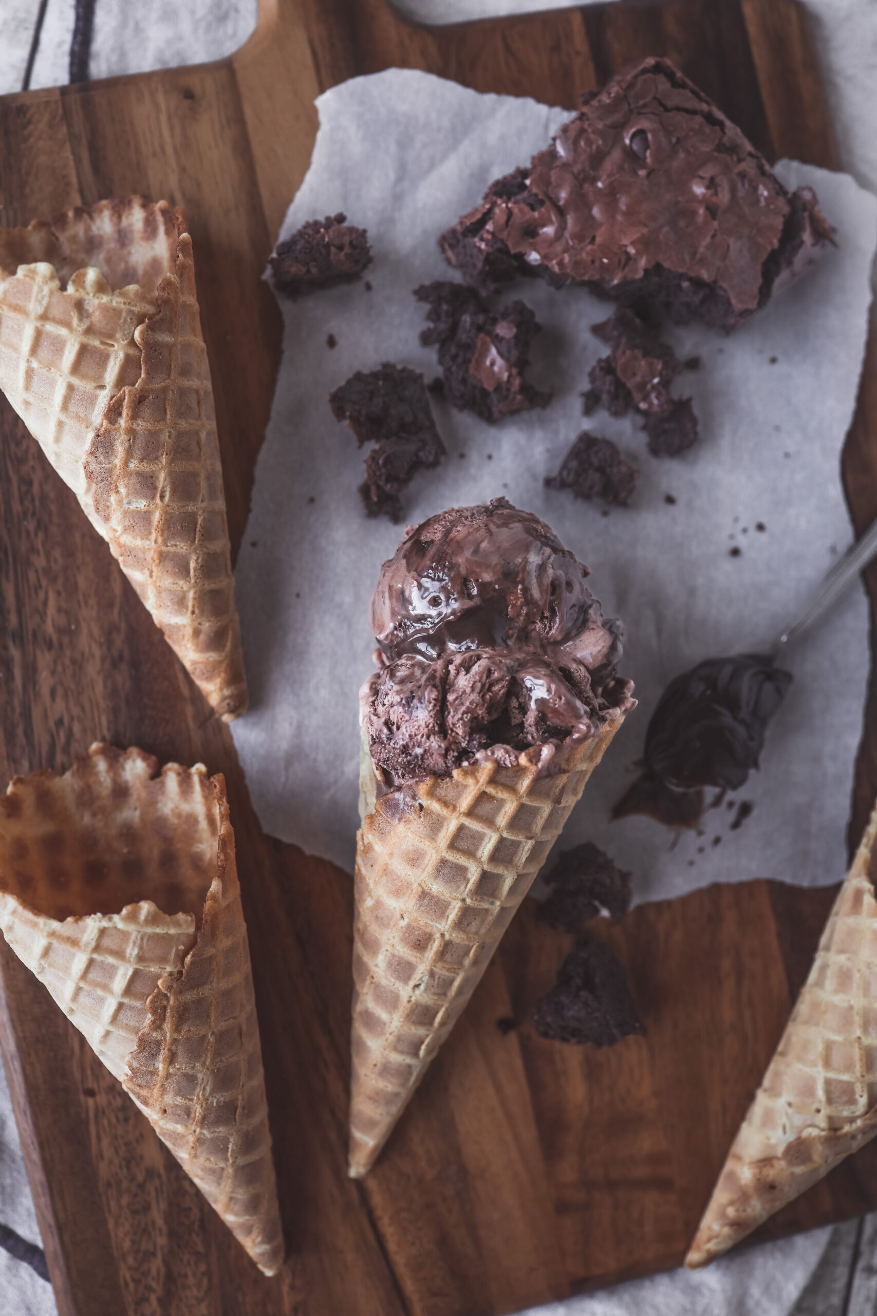 Scoop of rich and creamy no churn chocolate fudge brownie ice cream with chunks of brownie in a waffle cone