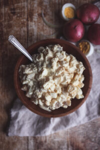 Classic Grandma’s potato salad in a white bowl, creamy and garnished, perfect for summer potlucks