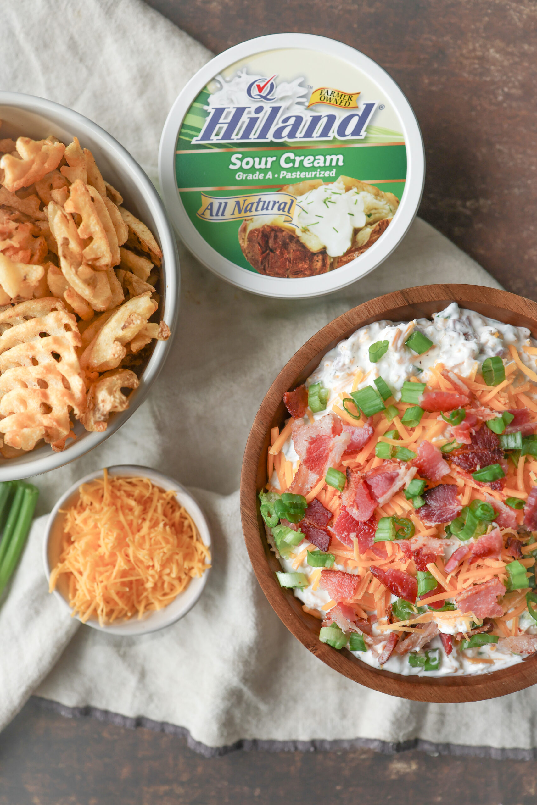 Loaded baked potato dip made with sour cream, cheddar cheese, bacon, and chives