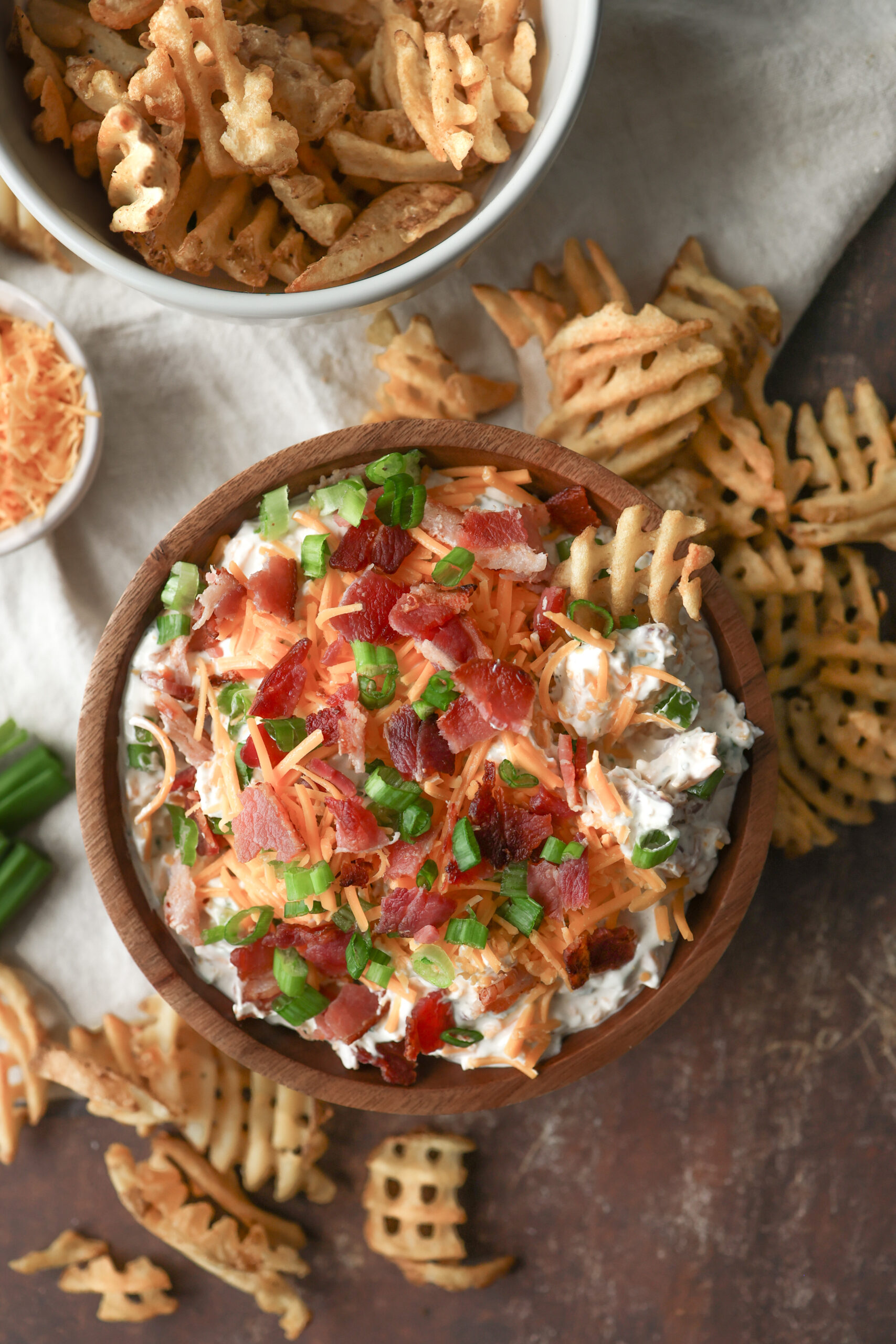 Loaded baked potato dip made with sour cream, cheddar cheese, bacon, and chives