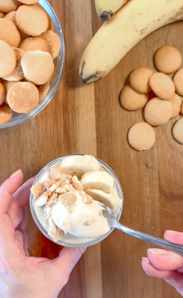 Overhead look of a jar filled with cottage cheese banana pudding and topped with nilla wafers and bananas