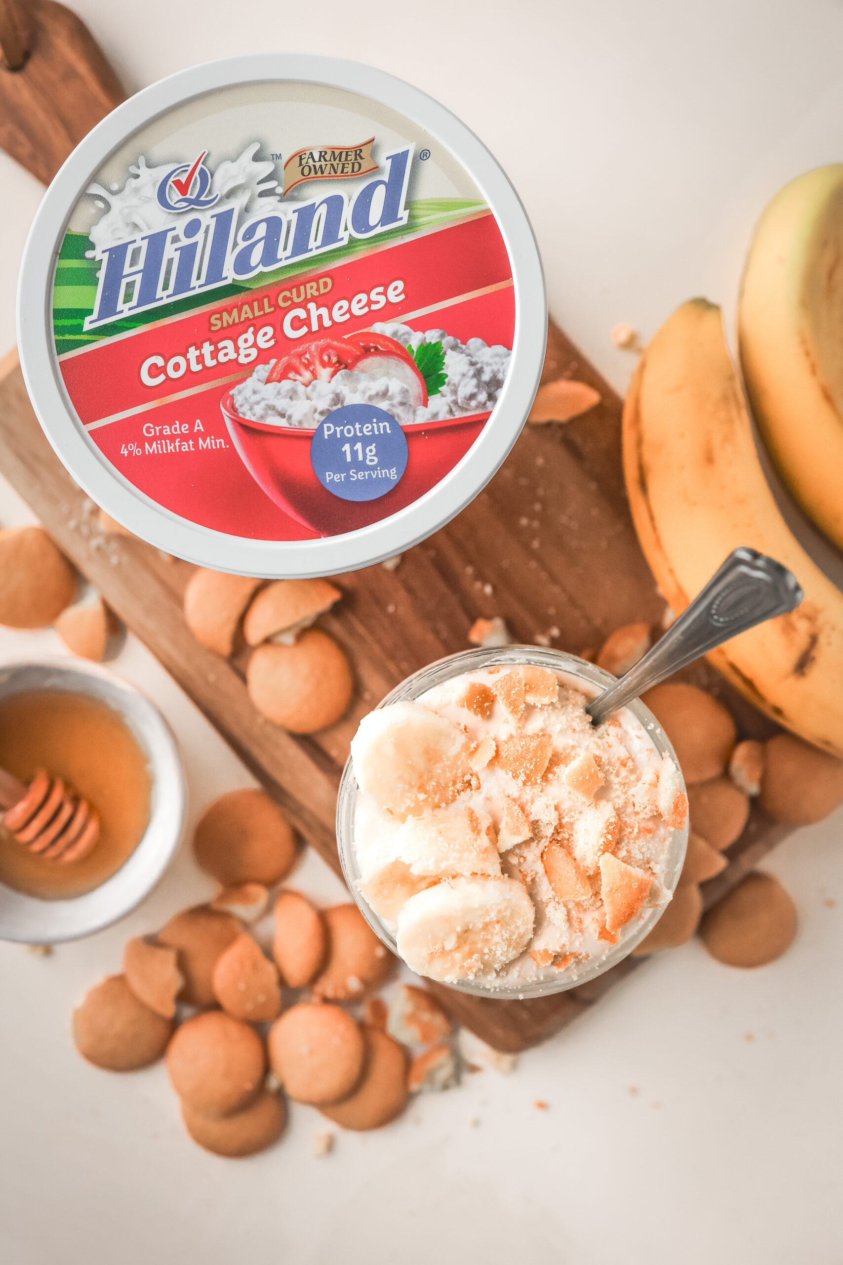 Overhead look of a jar filled with cottage cheese banana pudding and topped with nilla wafers and bananas