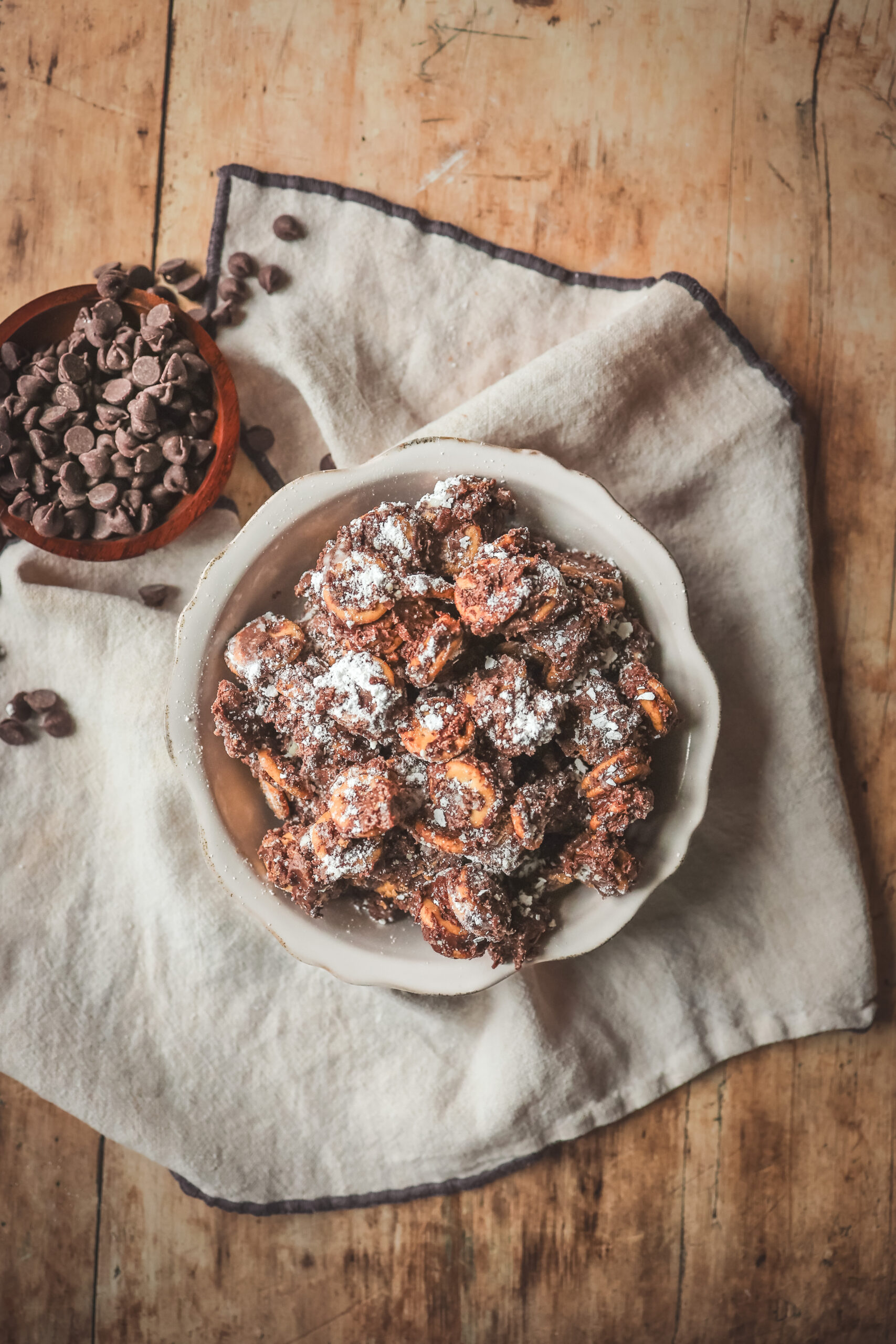 Bowl of Peanut Butter Ritz Cracker Puppy Chow dusted with powdered sugar