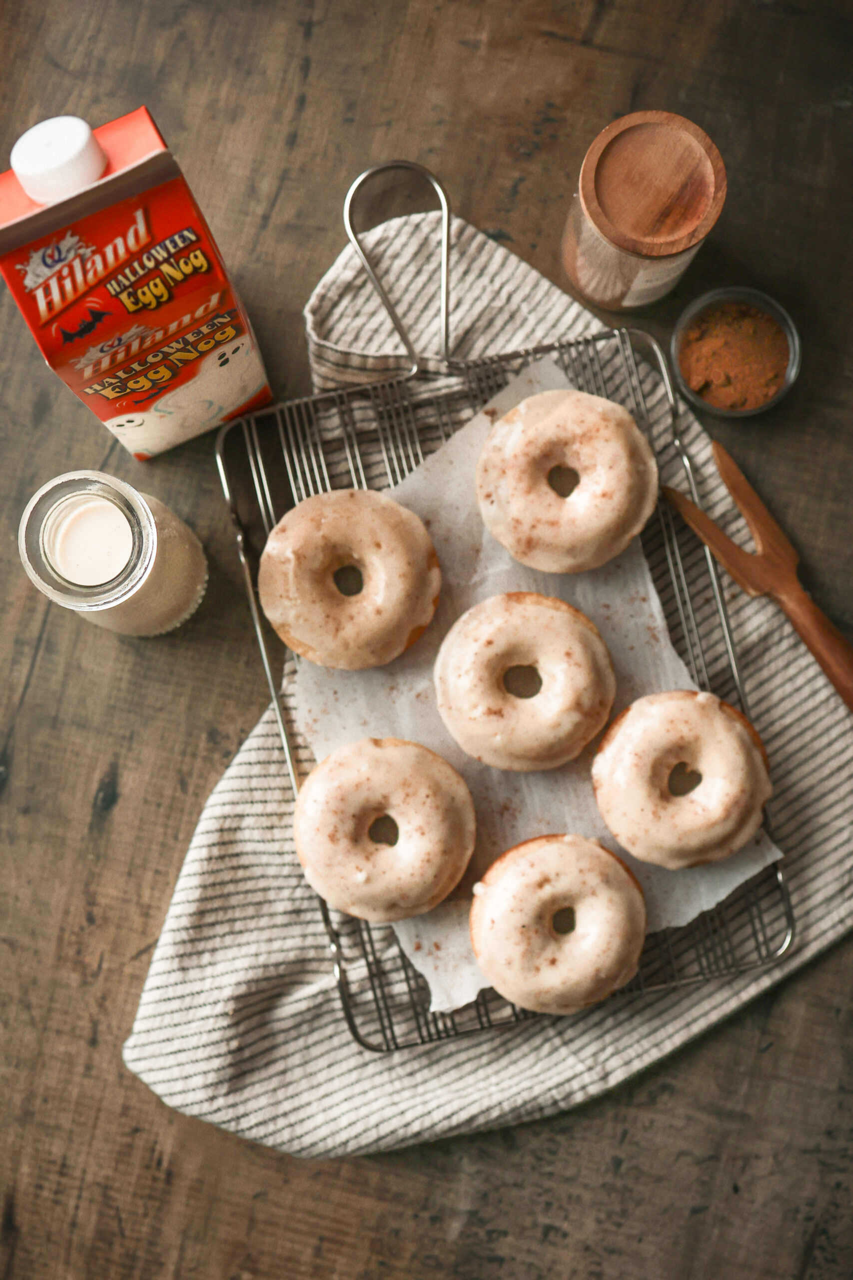 Baked eggnog donuts topped with a thick eggnog glaze and sprinkled with nutmeg