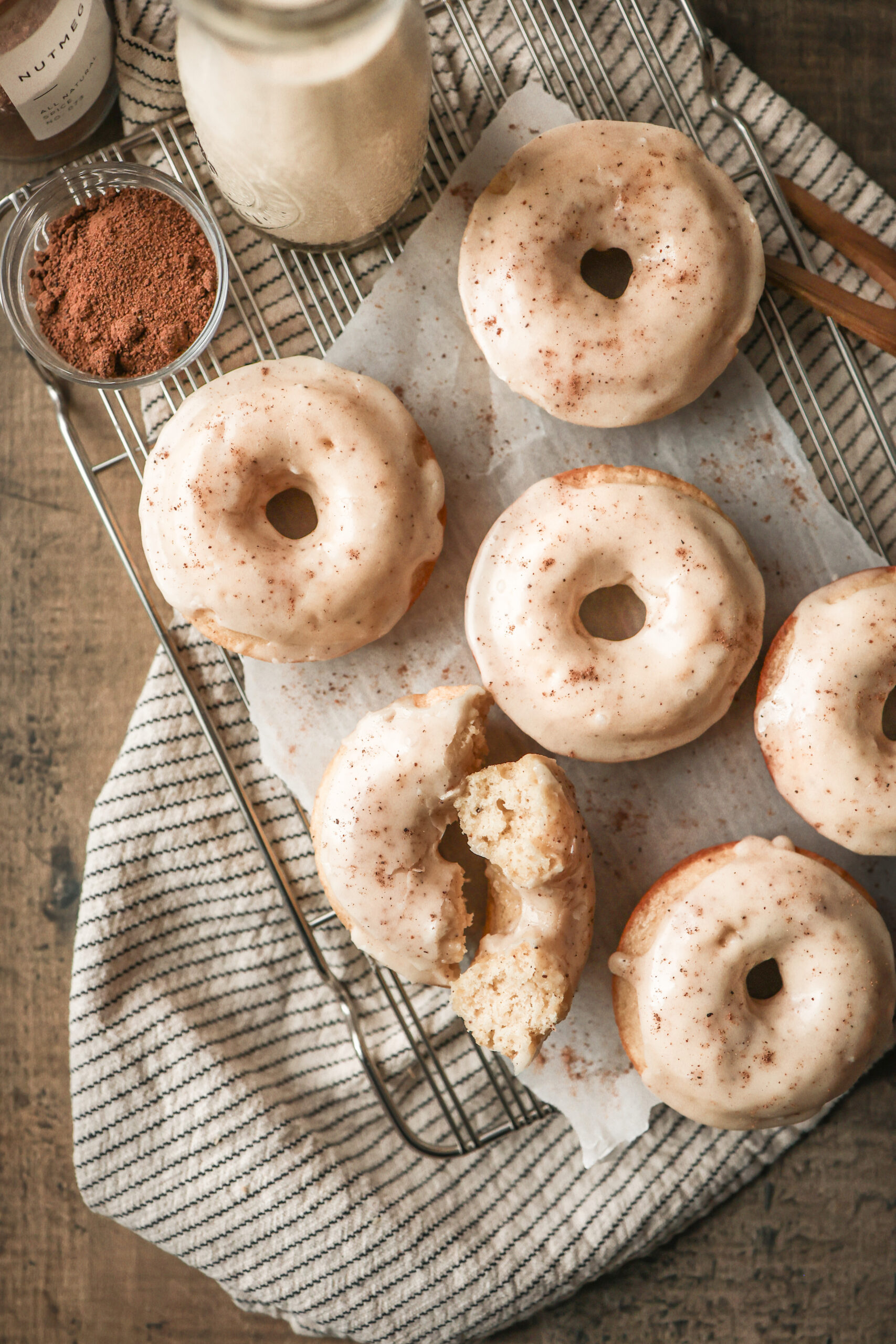 Baked eggnog donuts topped with a thick eggnog glaze and sprinkled with nutmeg
