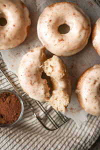 Baked eggnog donuts topped with a thick eggnog glaze and sprinkled with nutmeg