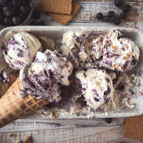 No churn blueberry pie ice cream in a loaf pan with a blueberry swirl topping