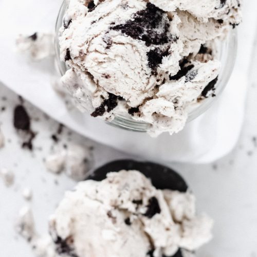 No churn cookies and cream ice cream in a loaf pan with Oreo cookie chunks