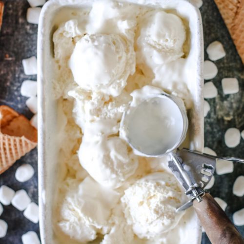 No churn marshmallow fluff ice cream in a bowl topped with mini marshmallows